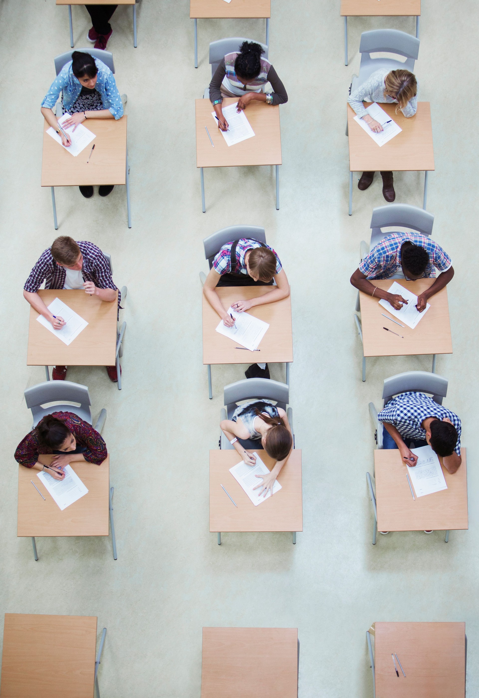 Overhead view of students writing their GCSE examination